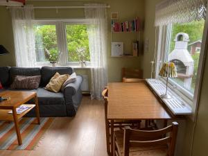 a living room with a couch and a table at Ullstorps Stugor in Höör