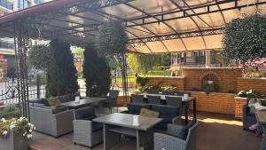 an outdoor patio with tables and chairs and a fireplace at Richky Hotel in Truskavets