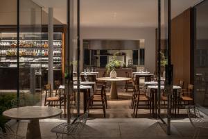 a restaurant with tables and chairs and a bar at R48 Hotel and Garden in Tel Aviv