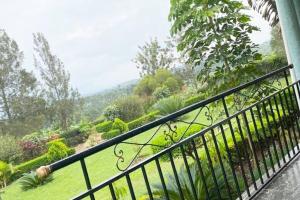 a balcony with a view of a garden at Orchard Home Homestay in Mbarara