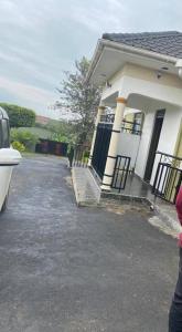 a house with a car parked in front of it at Orchard Home Homestay in Mbarara