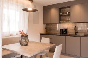 a kitchen with a wooden table with a vase on it at Obergasserhof Apt Tiroler in Riscone +26 photos
