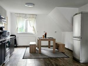 a kitchen with a table and a refrigerator at Work & Stay in Mannheim in Mannheim +4 photos