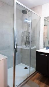 a shower with a glass door in a bathroom at Appartement à la montagne avec vue Imprenable in Gouaux-de-Larboust