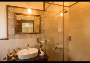a bathroom with a sink and a shower with a mirror at Sleeping Beauty by Nature Resorts and Stays in Coonoor +35 photos