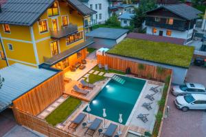 an aerial view of a house with a swimming pool at AlpinSpa zur Post in Bad Gastein
