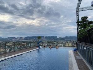a pool on top of a building with people in it at Riverside Hotel Hà Nam in Phủ Lý