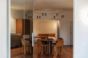 a dining room and kitchen with a table and chairs at The Bercin in Sydney