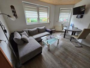 a living room with a couch and a table at Ferienwohnung Kehrer in Schwarzenberg