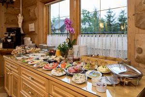 a table with many plates of food on it at Willa Izydor, widok na Tatry, pyszne posiłki in Kościelisko