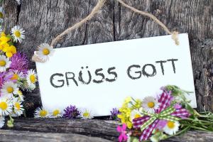 a sign that reads guests got with flowers on a table at Gästehaus Wiesegg in Reit im Winkl