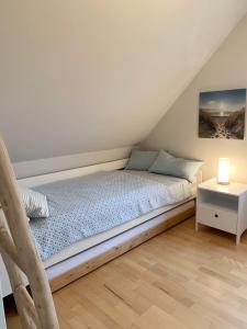 En eller flere senge i et værelse på Strandhaus Brasilien