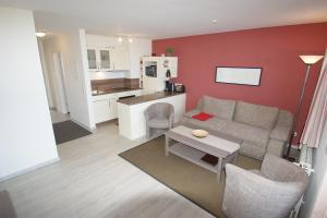 a living room with a couch and a table at Ostseeblick in Schönberger Strand