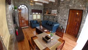 a living room with a blue couch and a table at The GreyStone FarmHouse, Turibari in Ranīchera