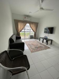 a living room with a couch and a chair at YAYA HOMESTAY CYBERJAYA & PUTRAJAYA in Cyberjaya +5 photos