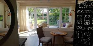 a living room with a white couch and a window at Jytte`s Annex in Kerteminde