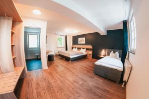 a large room with two beds and a room with at Palais in Erfurt