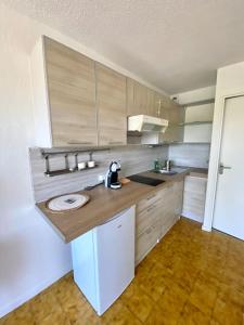 a kitchen with a counter and a sink in it at Studio apartment Fréjus in Fréjus