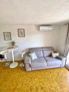 a living room with a couch and a table at Studio apartment Fréjus in Fréjus