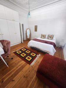 a bedroom with a bed and a table and a chair at The Quince & Olive in Parys