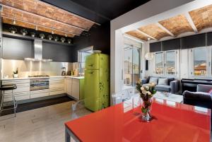 a kitchen with a green refrigerator and a red table at Stunning 2-bedroom Apartment With Two Terraces in Barcelona