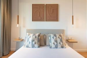 a bedroom with a white bed with pillows at Longbeach Smart Muchavista in Alicante