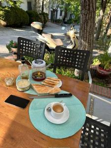 a table with a cup of coffee and bread on it at Casa Rural 3 en un fantástico legado in Alfacar