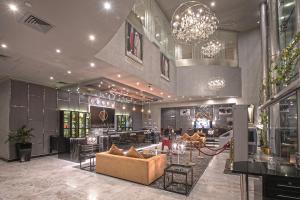 a lobby with couches and a bar in a building at The CASTLE PREMIUM HOTEL in Doha