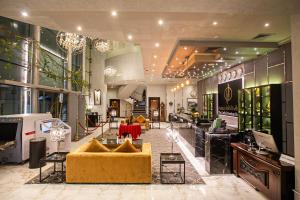 a lobby with couches and tables in a store at The CASTLE PREMIUM HOTEL in Doha