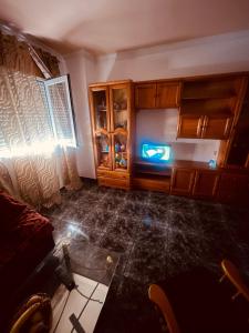 a living room with a couch and wooden cabinets at Аппартаменты Эль Эхидо in El Ejido