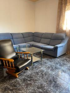 a living room with a couch and a chair and a table at Аппартаменты Эль Эхидо in El Ejido