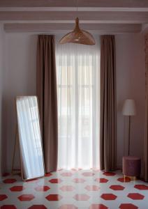 a room with a window with a chair and a floor at Suitetti Camere&Relax in San Nicola Arcella