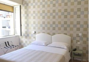 Postel nebo postele na pokoji v ubytování Hotel Del Golfo