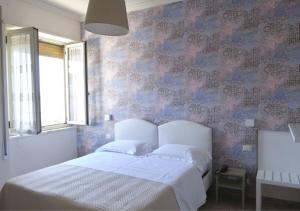 Postel nebo postele na pokoji v ubytování Hotel Del Golfo