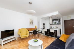 a living room with a couch and a table at Modern Apartment with FREE parking spot in Kraków