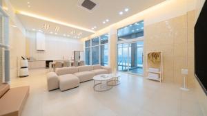a living room with a couch and a kitchen at Milos Pool Villa - K102 in Yeosu