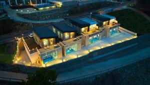 an aerial view of a house at night with lights at Milos Pool Villa - K102 in Yeosu