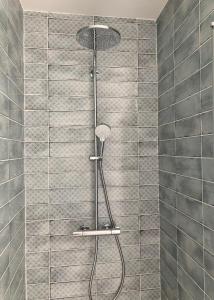 a shower with a shower head in a bathroom at Le Clos Guiton in La Rochelle