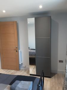 a bedroom with a closet and a mirror and a bed at 2 The Maltings Apartments in Shepton Mallet