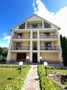 a building with a pathway in front of it at Сонячна Перлина in Polyana