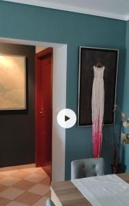 a room with a picture of a dress hanging on a wall at APARTMENT SYKIES THESSALONIKI in Thessaloniki