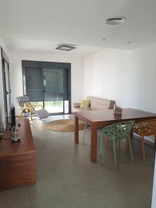 a living room with a wooden table and chairs at Casa Calafat in Calafat +22 photos