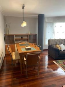 a living room with a table and a couch at Piso de la pala in Cambados