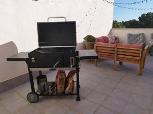 a barbecue grill on a cart on a patio at Casa Calafat in Calafat