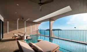 an indoor swimming pool with a view of the ocean at PARKROYAL Langkawi Resort in Pantai Cenang