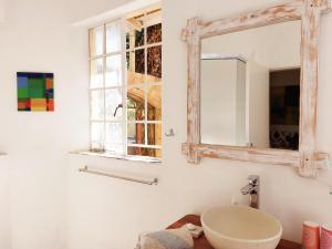 a bathroom with a sink and a mirror at Eins Art Studios in Omaruru