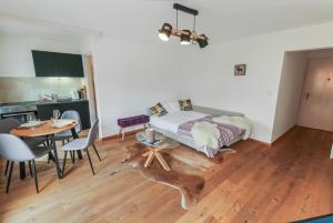 a bedroom with a bed with a table and chairs at Studio élégant au coeur de Crans in Crans-Montana