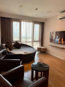 a living room with a bed and a couch at 3415B Mipec Riverside nice view in Hanoi