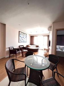 a living room with a glass table and chairs at 3415B Mipec Riverside nice view in Hanoi