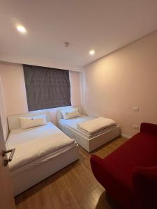 two beds in a room with a window at 3415B Mipec Riverside nice view in Hanoi